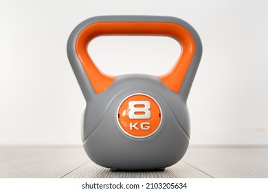 One Plastic Kettlebell Weight 8 Kg Gray And Orange Training Equipment On The Floor