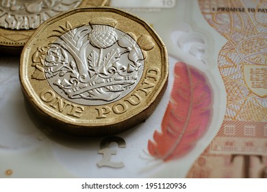 One pound coin with dramatic shadow. Concept. Selective focus. Macro.