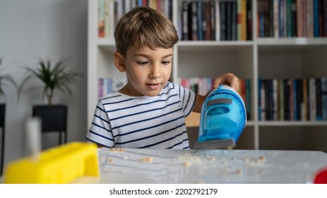 One Preschooler Boy Cleaning Mess On The Table With Hand Vacuum Cleaner After Playing And Making Experiments Helping With Home Cleaning Childhood Growing Up Concept