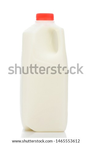 A one quart plastic bottle of milk, with red cap and no label., on white with reflection.