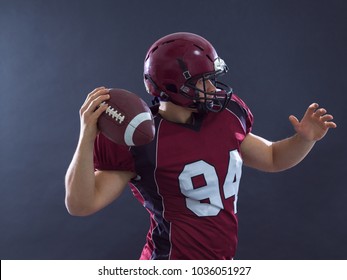 One Quarterback American Football Player Throwing Ball Isolated On Gray Background