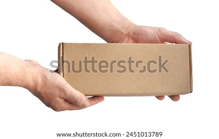 One rectangular cardboard box in hands on a plain light background. No recognizable people