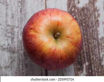 One Red Apple Overhead Over Wooden Background