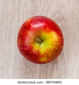 One Red Apple Top View. Wood Background