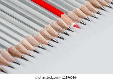One red color pencils among lead pencils