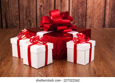 Happy Boxing Day Messages, Wishes, Quotes, And Images 36 one red gift box white gift boxes on a wood background