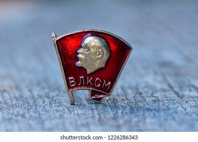 one red komsomol icon on a gray table