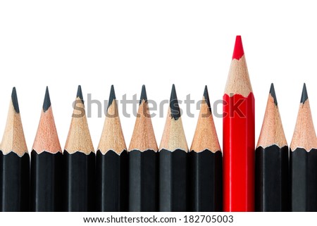 One red pencil standing out from the row of black pencils