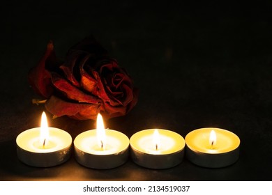 One Red Rose Of Roses With Candles On A Dark Background. Dramatic Mystical Atmosphere Of The Ritual Of Black Magic. The Concept Of Grief