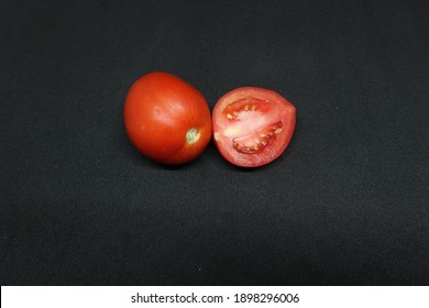 One Red Tomato And A Half That Placed Side By Side On A Black Background Also Its Good For Helth.