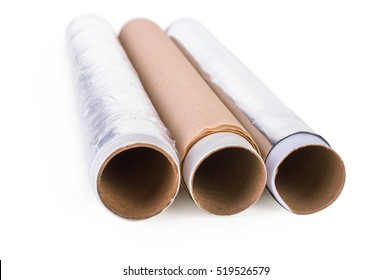 One Roll Of Plastic Wrap, One Roll Of Aluminum Foil And One Roll Of Parchment Paper For Household Use On A Light Background. Isolation.