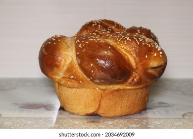 One round Sabbath, Yom Tov (Holiday) Challah with sesame seeds isolated on a Challah tray.
