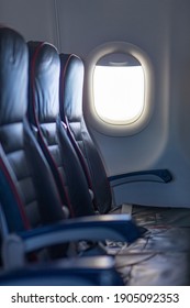 One Row Of 3 Empty Black Seats Inside Plane. Soft Focus, Selective Focus, Close-up, Vertical Shot.