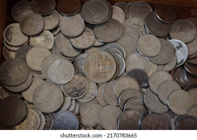 One rupee nickel coins of India. Heap of coins photographed. Large pile of money coins. Some of them are Corroded. Written in Hindi, Indian language. Bharat and one rupaya.
