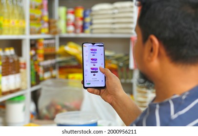 One Salesman Showing Thumbs-up With Smart Phone In Grocery  Store At Dhaka Bangladesh Photo Taken Date 3-4-2021