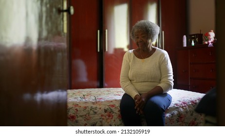 One Senior Black Woman Sitting By Bedside In Bedroom