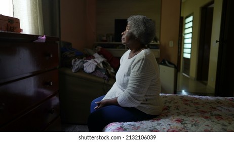 One Senior Black Woman Sitting By Bedside In Bedroom