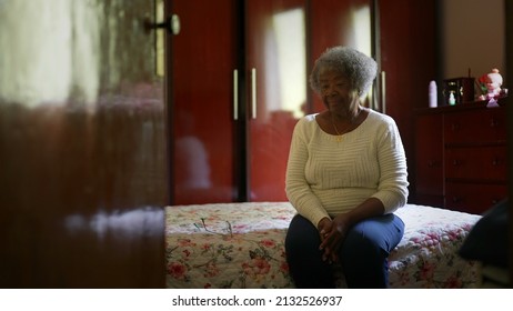 One Senior Black Woman Sitting By Bedside In Bedroom