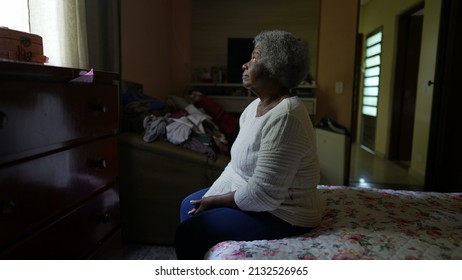 One Senior Black Woman Sitting By Bedside In Bedroom