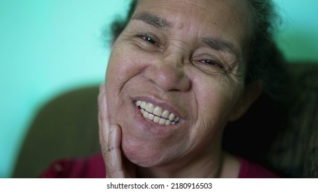 One Senior Hispanic Woman Looking At Camera Smiling. Portrait Of A South American Older Lady Closeup Face