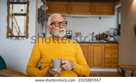 One senior man sit at home in the kitchen with cup of tea or coffee taking a brake from work or prepare for daily task morning routine real person copy space domestic life active senior