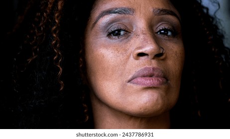 One serious black middle-aged woman close-up face looking at camera with intense gaze, upset judgemental expression of African American 50s lady - Powered by Shutterstock