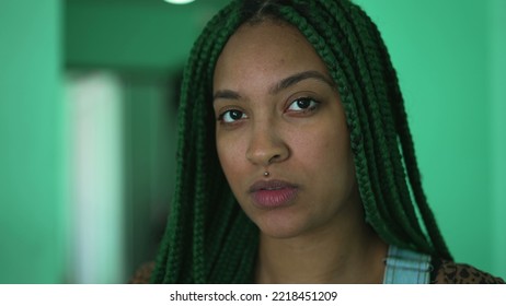 One Serious Young Black Woman With Green Box Braids Hairstyle