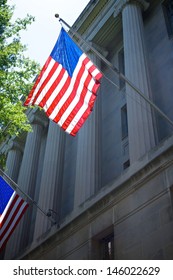 One of several US flags hangs from the side of the Department of Justice in Washington DC