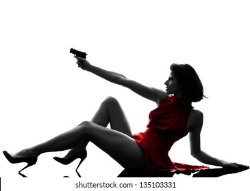 One Sexy Caucasian Woman Holding Gun In Silhouette Studio Isolated On White Background