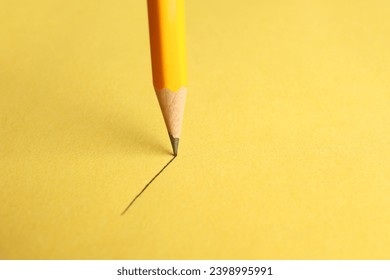 One sharp graphite pencil drawing on yellow background, closeup. Space for text