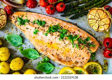 One sheet pan roast trout fillet with potatoes, asparagus and vegetables
