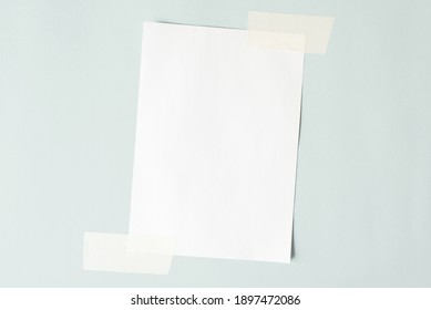 One Sheet Of Paper Crookedly Pasted On The Wall. White Sheet Mock Up, Copy Space.