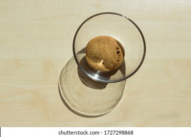 One Single Last Cookie Was Left In A Glass Transparent Plate On The Table.