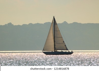 One Single Sailboat Sailing In The Great Lakes On Sparkling Water.