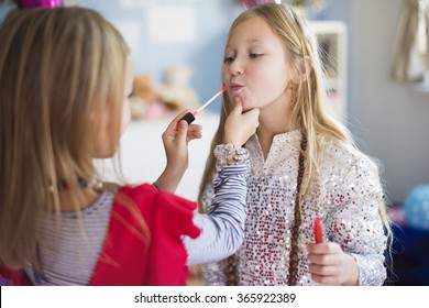 One Sister Helping Another With Doing Make Up