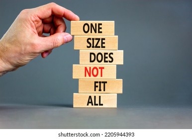 One Size Does Not Fit All Symbol. Concept Words One Size Does Not Fit All On Wooden Blocks. Businessman Hand. Beautiful Grey Background. One Size Does Not Fit All Business Concept. Copy Space.