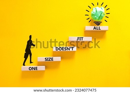 One size does not fit all symbol. Concept words One size does not fit all on wooden blocks. Beautiful yellow background. Businessman icon. One size does not fit all business concept. Copy space.