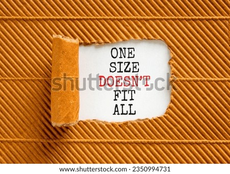 One size does not fit all symbol. Concept words One size does not fit all on beautiful white paper. Beautiful brown background. One size does not fit all business concept. Copy space.
