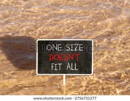 One size does not fit all symbol. Concept words One size does not fit all on beautiful blackboard. Beautiful Red sea water background. Business one size does not fit all concept. Copy space.