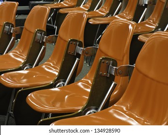 One Size Fits All: Identical Shiny Hard Orange Molded Seats In Lecture Hall