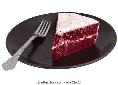 One Slice Of Red Velvet Cake On A Black Plate With A Fork Isolated Over White