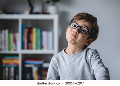 One Small Caucasian Boy Close Up Looking To The Camera While Standing At Home Wearing Eyeglasses And Making Fun Faces And Gesture Real People Copy Space