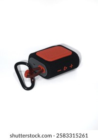 One small music bok with basic colors of black and orange linked to a black carabiner with red stripes