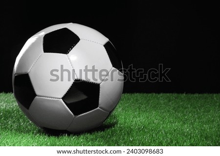 One soccer ball on green grass, space for text. Sports equipment