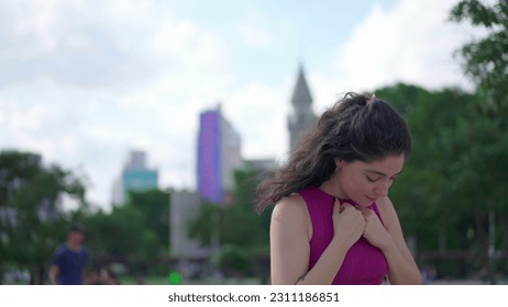 One spiritual young woman standing outdoors raising arms to sky feeling HOPE and FAITH. A joyful person looking UP feeling GRATITUDE - Shutterstock ID 2311186851