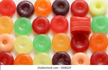 One square candy in colorful array of round candies