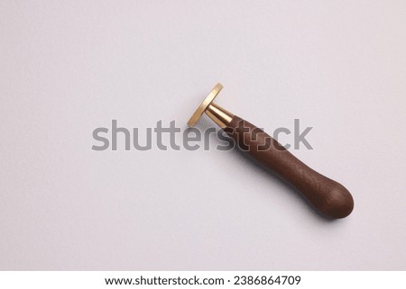 One stamp tool on light grey background, top view. Space for text