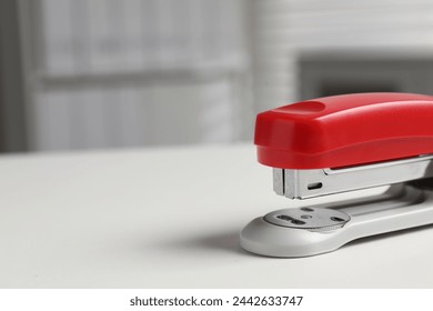 One stapler on white table, closeup. Space for text