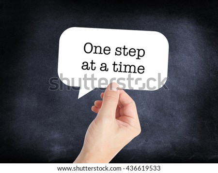 One step at a time written on a speechbubble