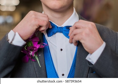 One Teen Boy Adjusts Blue Striped Bow Tie. Getting Dressed And Ready For Formal High School Prom Dance.